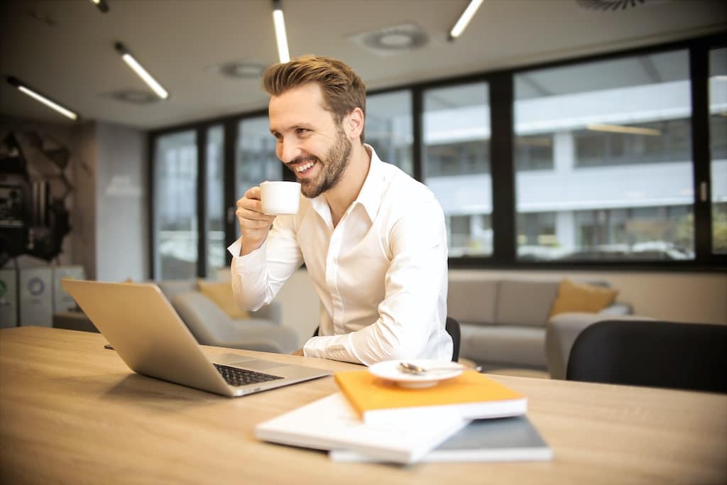 business man smiling and feeling happy as he works a job he loves