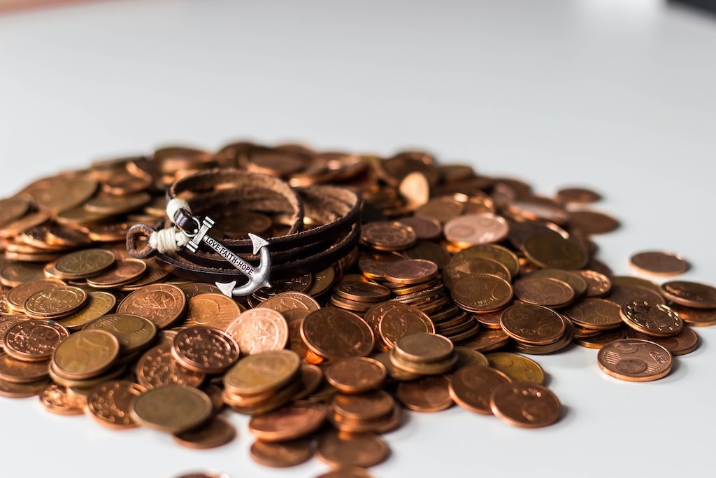 pennies and an anchor to represent the small investments through acorns and how they lay a strong anchor or foundation for your investment future