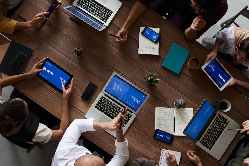 group of people showing self-discipline by sitting through a boring meeting at work