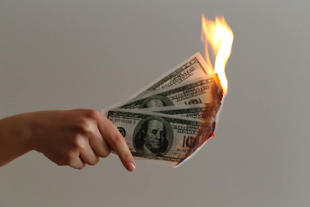 wasting money burning money