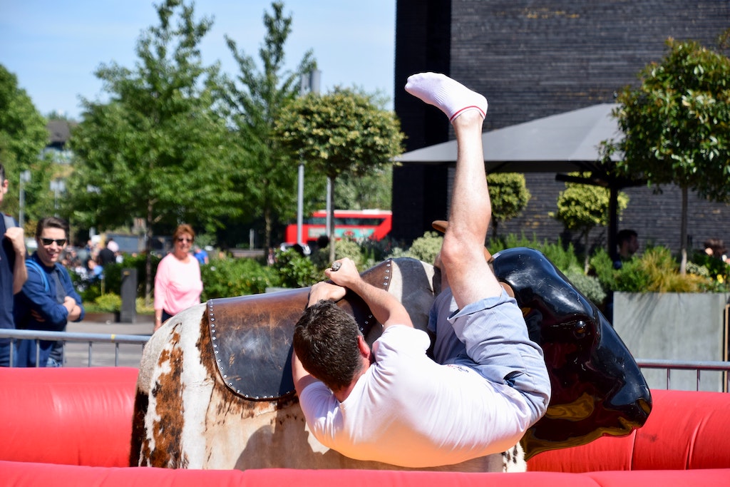 man falling off mechanical bull after taking every opportunity to find what drives him to know what should i do with my life